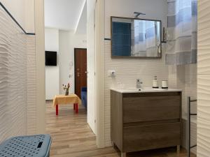 ein Bad mit einem Waschbecken und einem Spiegel in der Unterkunft Suite de la Sicilienne in Castellammare del Golfo