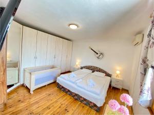 a small room with a bed and a bathroom at Villa Stella - private house with parking spot, pool and sea view in Varna City +19 photos