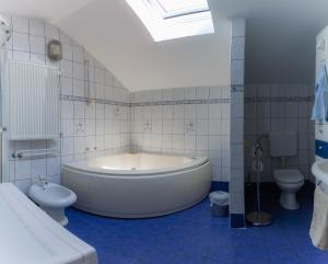 a bathroom with a tub and a toilet and a sink at Rooms Kozarje in Ljubljana