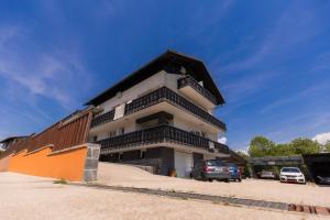 a building with cars parked in front of it at Rooms Kozarje in Ljubljana +33 photos