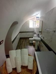 a bathroom with a sink and a pile of towels at Guesthouse Çelo in Gjirokastër