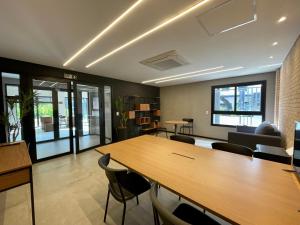 an office with a large wooden table and chairs at Meu Club Haas in Sao Paulo +156 photos