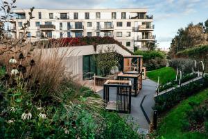 a view of a building and a garden with a building at Sea Shell Stadium Brzeźno Beach in Gdańsk