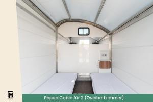 a small room with white walls and a ceiling at Kieler Woche Lodge Camp in Kiel