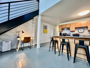 a kitchen with a counter and stools in a room at New renovated Loft in Old factory by Kings Island in Maineville