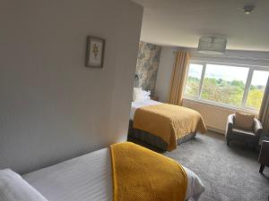 Postel nebo postele na pokoji v ubytování Braeburn Guesthouse