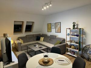 a living room with a couch and a table at Apartment 075 in Tuzla