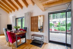 a dining room with a table and chairs and a window at Schorenmoos Lodge in Dietmannsried