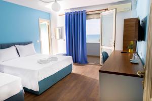 a hotel room with a bed and a view of the ocean at Hotel Vila MAX in Durrës