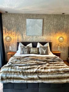 a bedroom with a large bed with a blanket at Chalet Maya in Schladming