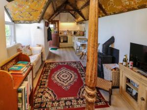 ein Wohnzimmer mit einem großen Bett in einem Zimmer in der Unterkunft Toad Hall Cottage in Totnes