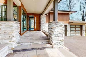 a home with a stone walkway leading to the front door at Heaven - Private Pool, Hot Tub, View, Steam Shower in Knoxville