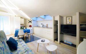 Una sala de estar y una cocina con un sofá y una mesa. en MONTEROSSO GARDEN House PLUS, en Monterosso al Mare