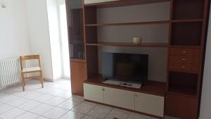 a living room with a entertainment center with a television at Welcome to Ossola in Trontano