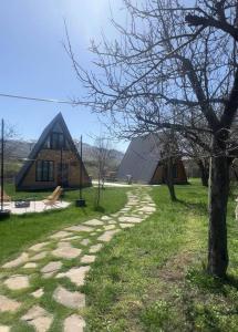 a stone path leading to a building with a dome at Lake House A Frame in Gyulagarak