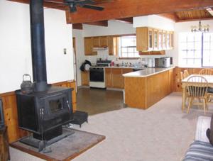 a kitchen with a stove in the middle of a room at Bear Paw Lodge in Vallecito