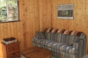 a living room with a couch and a table at Bear Paw Lodge in Vallecito