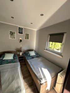 um quarto com 2 camas e uma janela em Domek Letniskowy em Puck