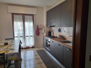 a kitchen with gray cabinets and a sink at Dolomiti House LOC-00067 in Lamon +49 photos