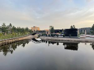 a bridge over a river in a city at Duneville Apartments Mano Jūra 2 in Palanga