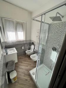 a bathroom with a shower and a sink and a toilet at Casa di Sara in Rapallo