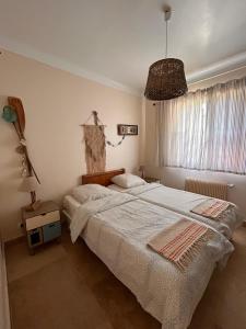 a bedroom with a bed and a large window at Villa Retour de Plage in Anthéor