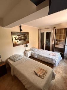 a bedroom with two beds and a painting on the wall at Villa Retour de Plage in Anthéor +22 photos