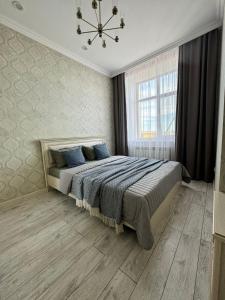 En eller flere senge i et værelse på A-Six Apartment ЖК "Новый Степной"