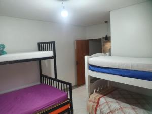 a dorm room with two bunk beds and a stool at Chácara Rosa Maria in São Paulo +35 photos