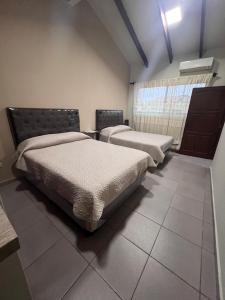 a room with two beds and a window at Casa bonita y cómoda in Santa Cruz de la Sierra
