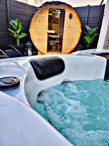a jacuzzi tub with blue water in a room at Lions Place Premium Apartments COMFORT optionaler Zugang zum SPA- Bereich in Heidenheim an der Brenz
