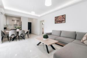 a living room with a couch and a table at Zante Melina's Apartment in Argasi