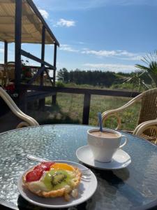 a cup of coffee and a pastry on a table at Stilo Country Dargobądz in Wolin