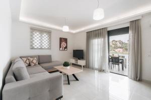 a living room with a couch and a table at Zante Melina's Apartment in Argasi