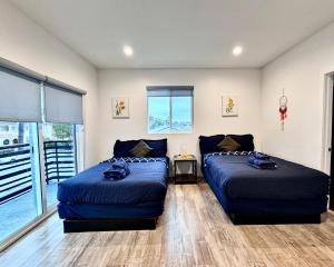 1 dormitorio con 2 camas y ventana en 4BR/4BR modern house at Mid-city en Los Ángeles