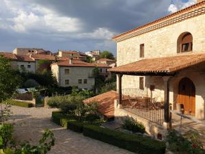 a stone building with a gazebo in a city at Casa Rural don Rosendo in Olmeda de Cobeta