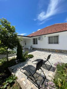 a patio with two chairs and a house at Countriside Holiday Villa 