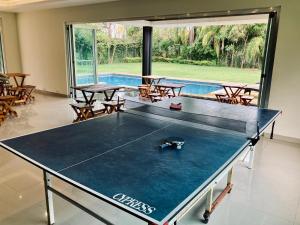 a ping pong table in a room with a pool at Cozy Suite In Bacab Mansion in Cancún