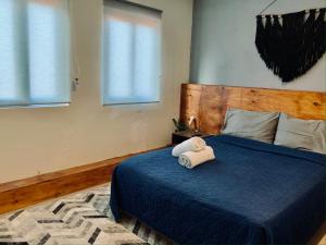 a bedroom with a blue bed with a stuffed animal on it at Cozy Suite In Bacab Mansion in Cancún