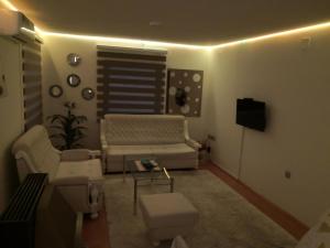 a living room with a couch and a table at Apartment Mirror in Visoko