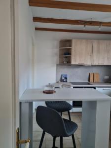a kitchen with a white table and a chair at Ferienwohnung im Rurtal in Kreuzau