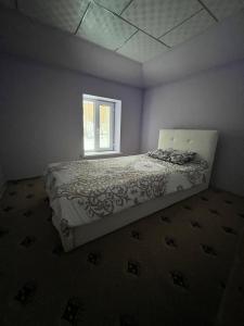 1 dormitorio con cama y ventana en Bagu HOMESTAY, 