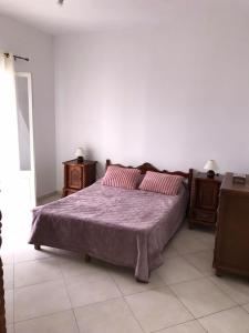 a bedroom with a bed and two night stands at Bel appartement Ghazaouet vue sur mer in Ghazaouet