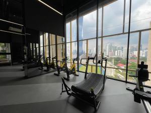 a gym with a bunch of treadmills in a building at Opus Residence Kuala Lumpur By Great Service in Kuala Lumpur