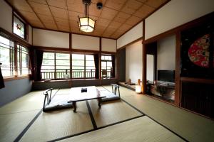 ein Wohnzimmer mit einem Tisch in einem Zimmer mit Fenstern in der Unterkunft Hatago Kayausagi in Hita + 30 Fotos