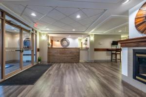 an empty lobby with a fireplace and a counter at Pilgrim Inn in Caronport