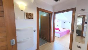 a room with a bed and a door to a bedroom at "el señor de treville" in Barro de Llanes