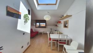 a kitchen and dining room with a table and chairs at "el señor de treville" in Barro de Llanes