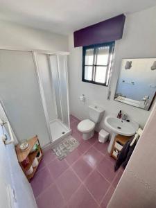 a bathroom with a toilet and a shower and a sink at Chalet en Real de la Barrosa in Chiclana de la Frontera
