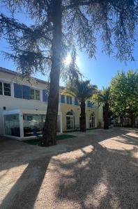 a building with palm trees in front of it at Chambre de charme n5 in Grimaud